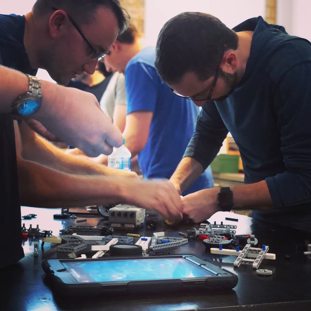 Children working together on a hands-on STEAM project at TinkerTank